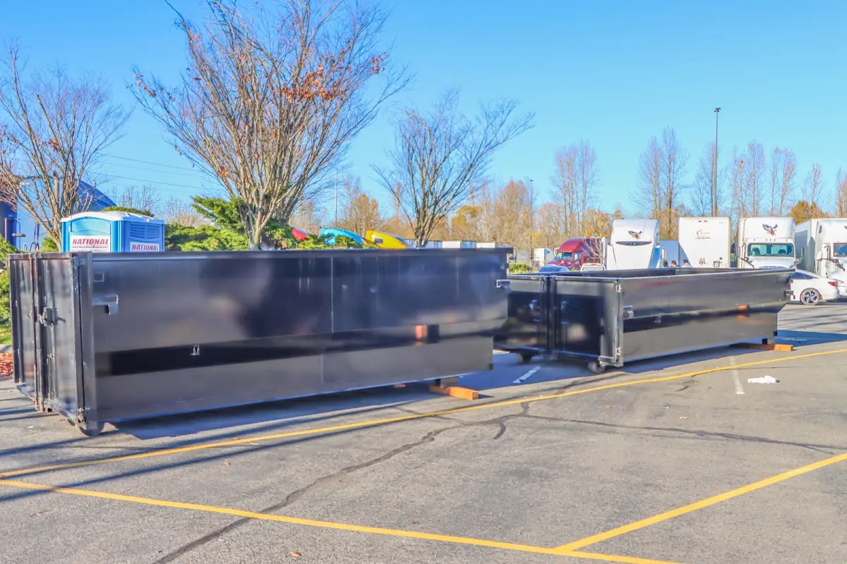 Professional dumpster rental service with roll-off container on residential driveway in Canby